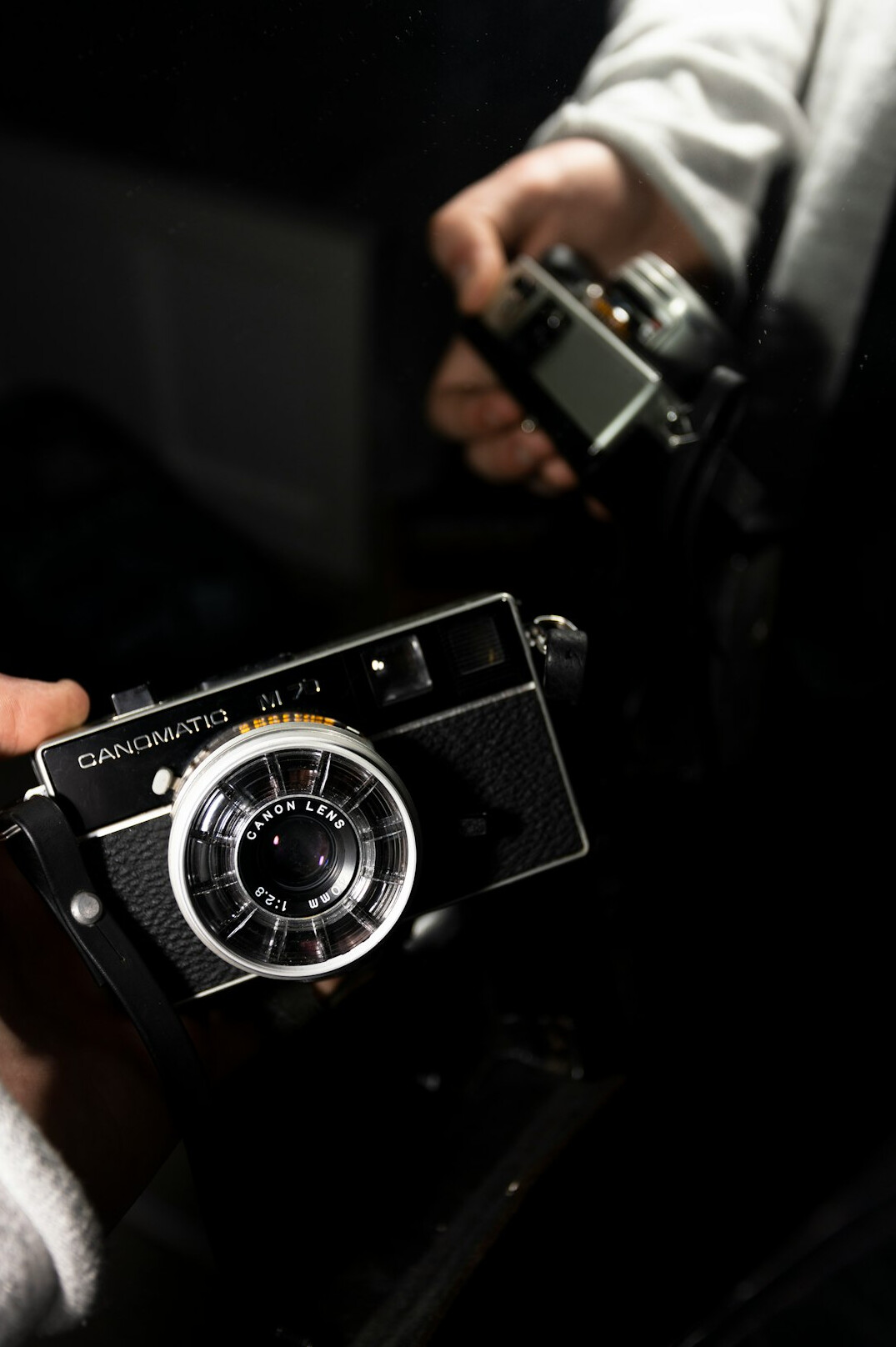 Hands of a photographer adjusting the settings on a vintage film camera