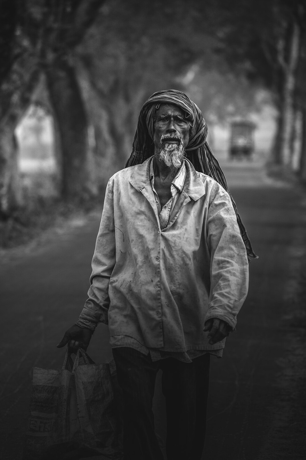 Weathered portrait of an elderly Indigenous Canadian man standing on a quiet street
