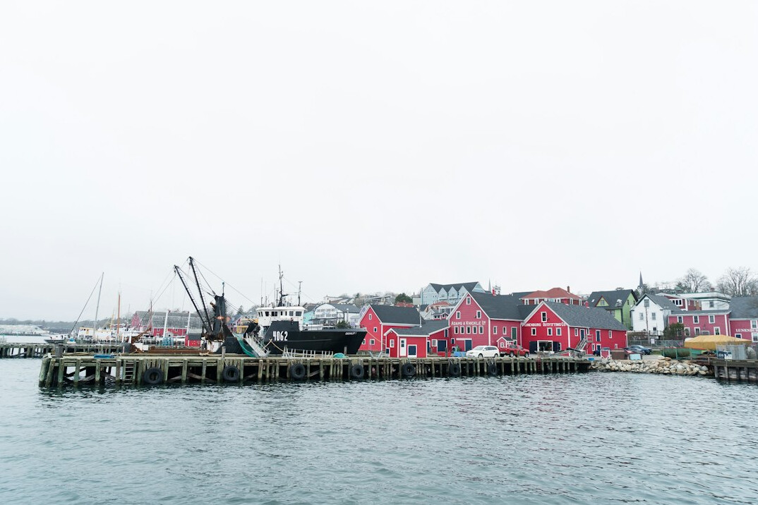 Colorful fishing boats docked in a small Nova Scotia harbor village
